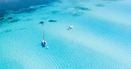 View from above, stunning aerial view of some boats sailing on a beautiful turquoise clear water....