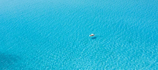 Printed roller blinds La Pelosa Beach, Sardinia, Italy View from above, stunning aerial view of an inflatable boat with tourists on board sailing on a beautiful turquoise clear water. Spiaggia La Pelosa (Pelosa beach) Stintino, Sardinia, Italy.