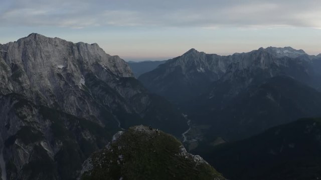 Group Of People With Dog On Top Of The Mountain Pan Down To The Edge Of The Mountain, Mangart Bovec, Slovenia