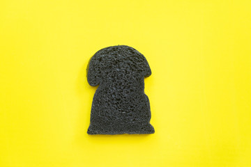 Organic bio charcoal bread on yellow background