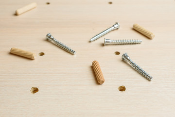 Furniture assembly using a tools, cordless screwdriver, clips and clamps close up.  Assembling Flat Pack Furniture