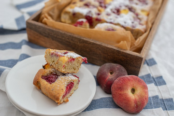 Home made almond cake with peach and raspberries