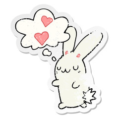 cartoon rabbit in love and thought bubble as a distressed worn sticker