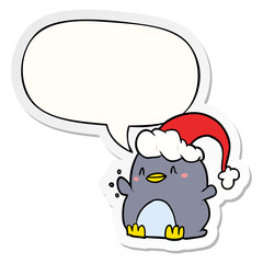 cartoon penguin wearing christmas hat and speech bubble sticker