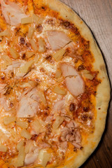 top view macro of pizza with prosciutto and pineapple pieces