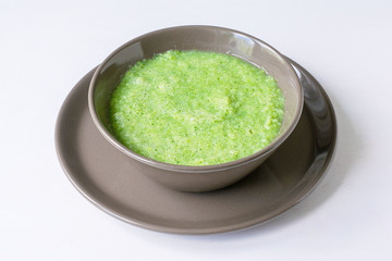 Vegetarian soup of broccoli puree on a white background. The concept of healthy eating.