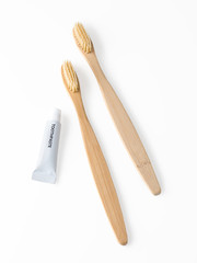 Bamboo toothbrush with toothpaste isolated on white
