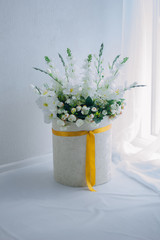 texture. White flowers in a white vase. Delicate interior.