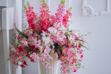 texture. Pink flowers in a white vase. Delicate interior.