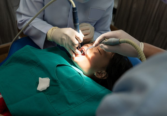 Asian girl met the dentist for routine dental checkup and consultant.