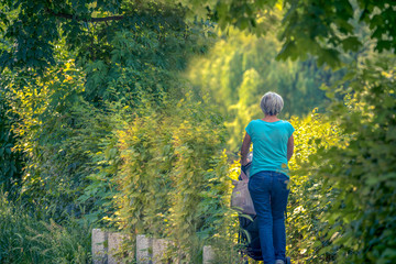 Grandma goes to a baby walk with a trolley
