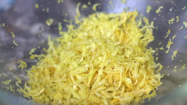 In a glass bowl RUB the lemon zest