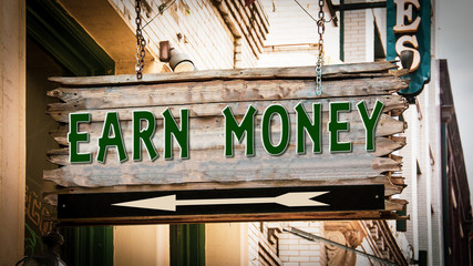 Obraz premium Street Sign Earn Money