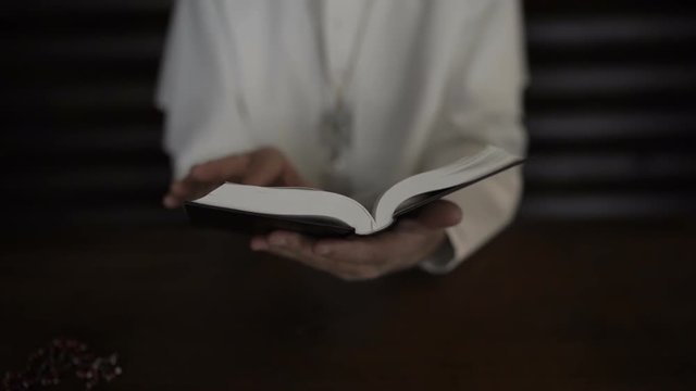 Pope reads the Bible in his office. Slow motion 100 fps