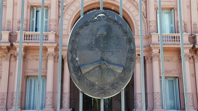Casa Rosada (Pink House), Presidential Palace in Buenos Aires, Argentina, with National Emblem. Pollen Particles Floating in the Air.
