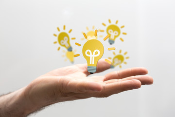  holding illuminated light bulb, idea, innovation and inspiration concept.