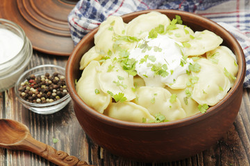 A ceramic bowl with freshly cooked Russian vareniki with mashed potato