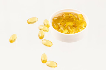 Yellow pills on white background