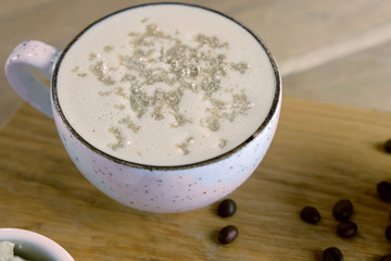 Cup of coffee with halva served on a tray with honey and coffee beans