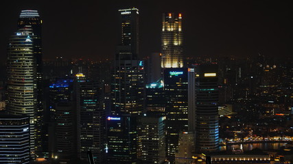 Fototapeta na wymiar Singapore skyscraper and office at night. Financial district where businessman make business.