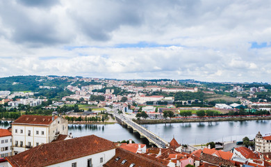 Fototapeta na wymiar Cityscape over the roofs of Coimbra with the Mondego River, Portugal