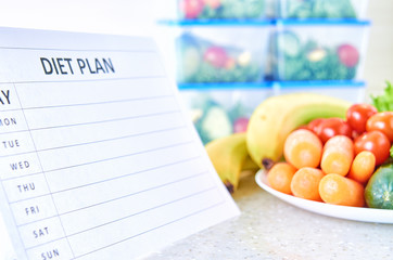 A meal plan for a week on a white table among set of plastic containers for food and food. Proper nutrition during the week.