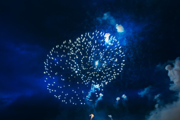 Naklejka na ściany i meble Inexpensive fireworks, over the city sky, green and blue. For any purpose use. 