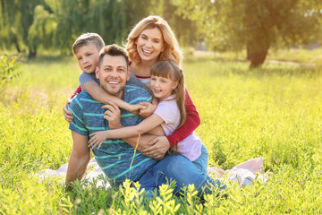 Happy family resting in park