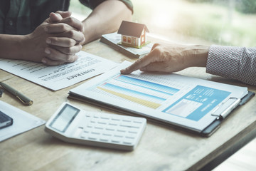 Real estate agents discussing about loans and interest rates for buying houses for customers who come to contact. contract and agreement concepts.