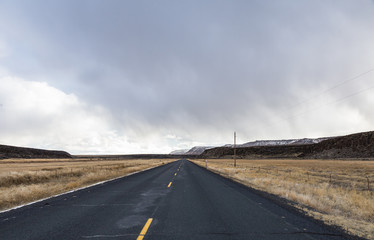 Road ahead with storm clouds above mountain in Oregon, USA
