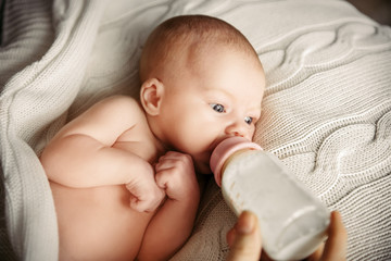 Artificial lactation and baby bottle feeding. Maternity and healthy lifestyle concept.