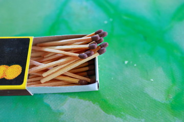 Matches in box, green background