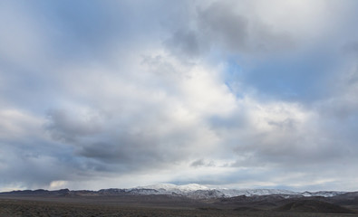 Overcast sky above snow capped mountain