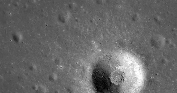 Medium-altitude overflight aerial of unnamed impact crater south of Dorsum Zirkel, in Mare Imbrium. LAT 26.94 LONG 336.77. Clip loops and is reversible. Elements of this image furnished by NASA