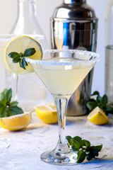 Margarita cocktail, Alcoholic drink, Margarita cocktail with lemon and mint on a bright table. bar. bar supplies and accessories