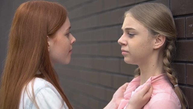 Young female bullying scared teenager, physical and emotional abuse, aggression