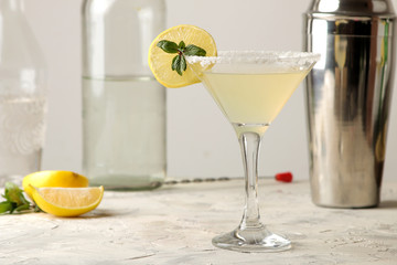 Margarita cocktail, Alcoholic drink, Margarita cocktail with lemon and mint on a bright table. bar. bar supplies and accessories