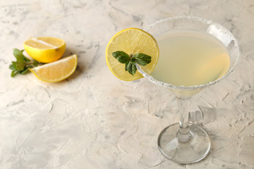 Margarita cocktail, Alcoholic drink, Margarita cocktail with lemon and mint on a bright table. bar. bar supplies and accessories