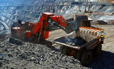 Large quarry dump truck. Loading the rock in the dumper. Loading coal into body work truck.