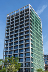 Obraz premium Tall and modern looking office building with green windows in Valencia, Spain