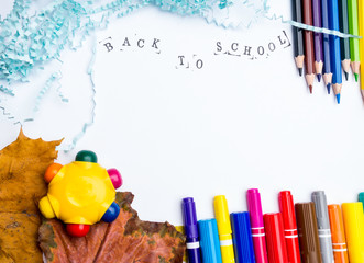 alphabet in wooden box, colorful pencils and markers, dry autumn leaves isolated on white background, Hello school, 1st September concept