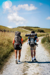 hikers with their backpacks in the paths in summer