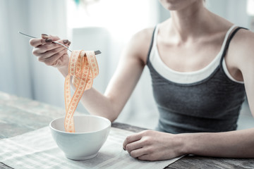 Close up of female hand that holding fork