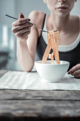 Focused photo on female hand that raising fork