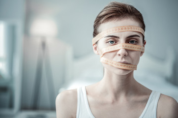 Concentrated young woman looking straight at camera