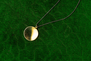 luxury vintage golden round pendant jewelry with chain necklace accessory for women on green velvet...