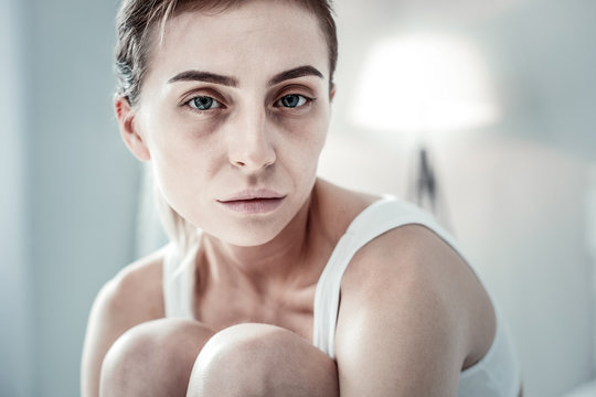 Serious brunette girl looking straight at camera