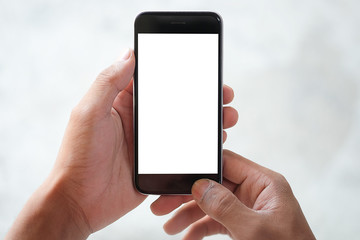 Cropped shot view of man hands holding smart phone with blank copy space screen for your text message or information content, female reading text message on cell telephone during in urban setting. 