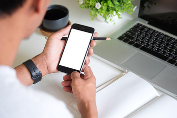 Cropped shot view of man hands holding smart phone with blank copy space screen for your text message or information content, female reading text message on cell telephone during in urban setting. 