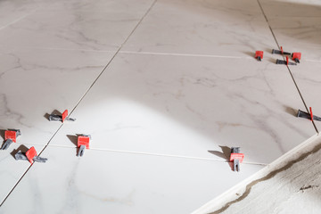 Tile leveling system with plastic clips and wedges